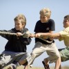 children boys playing tug of war
