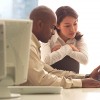 Managers reading laptop