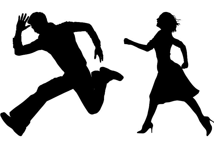 silhouette image of man and woman running