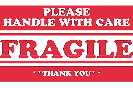 Red and white lettering sign that says Fragile, please handle with care
