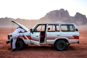 car being repaired in desert