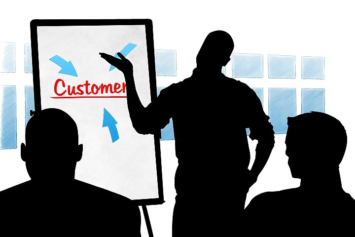 silhouette image of a person making a presentation about customers
