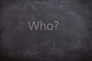 the word "who" written on a blackboard