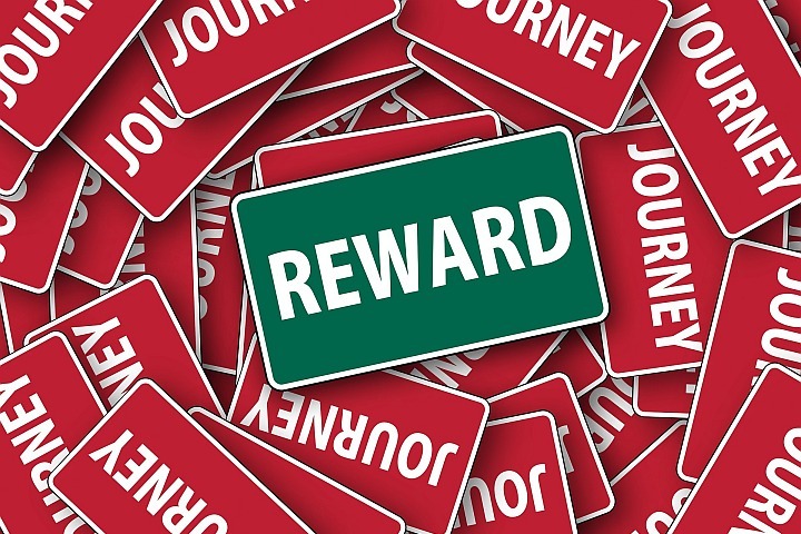 reward sign sitting on journey signs