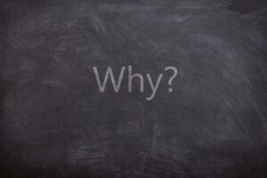The word WHY written on a chalkboard