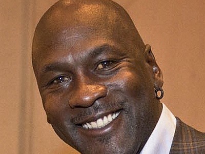 Michael Jordan in business attire smiling