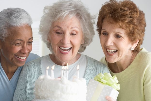 Three older women celebrating birthday