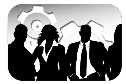silhouette of business people standing in front of gears