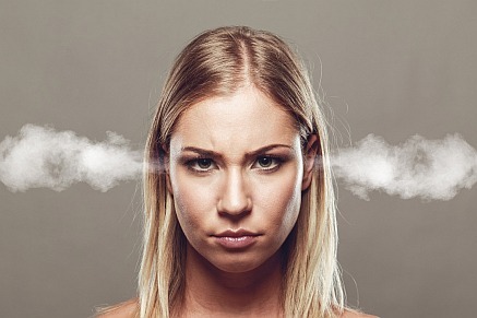 a young woman with a frustrated look on her face and steam coming out of her ears
