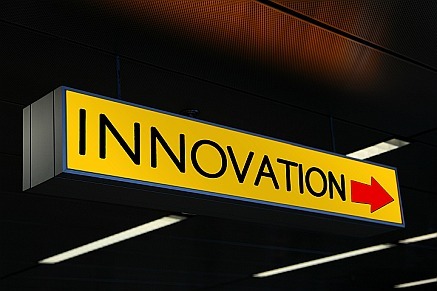 a yellow sign with the word innovation in it and a red arrow pointing to the right