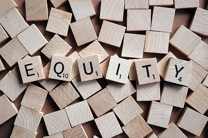 the word "equity" spelled out in scrabble tiles