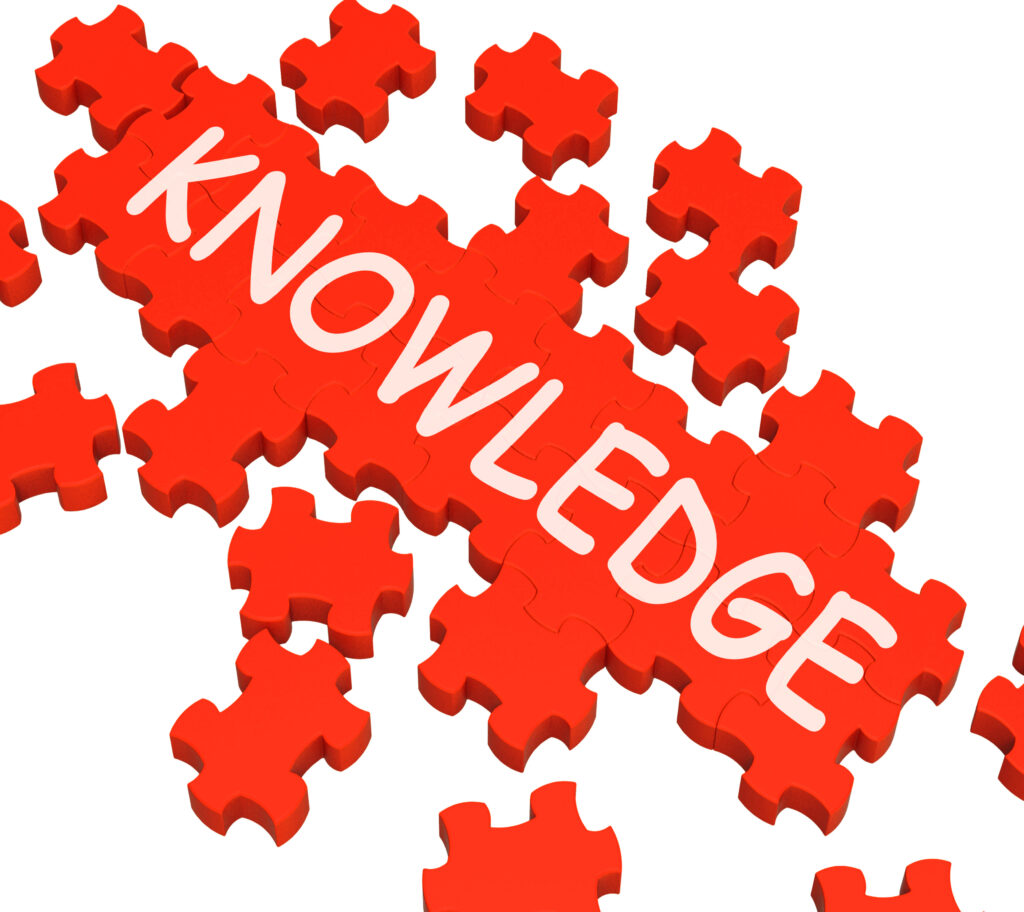 the word "knowledge" shown in white text on red puzzle pieces